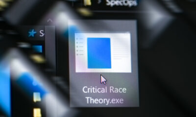 Mouse cursor about to double-click and run 'Critical Race Theory' executable