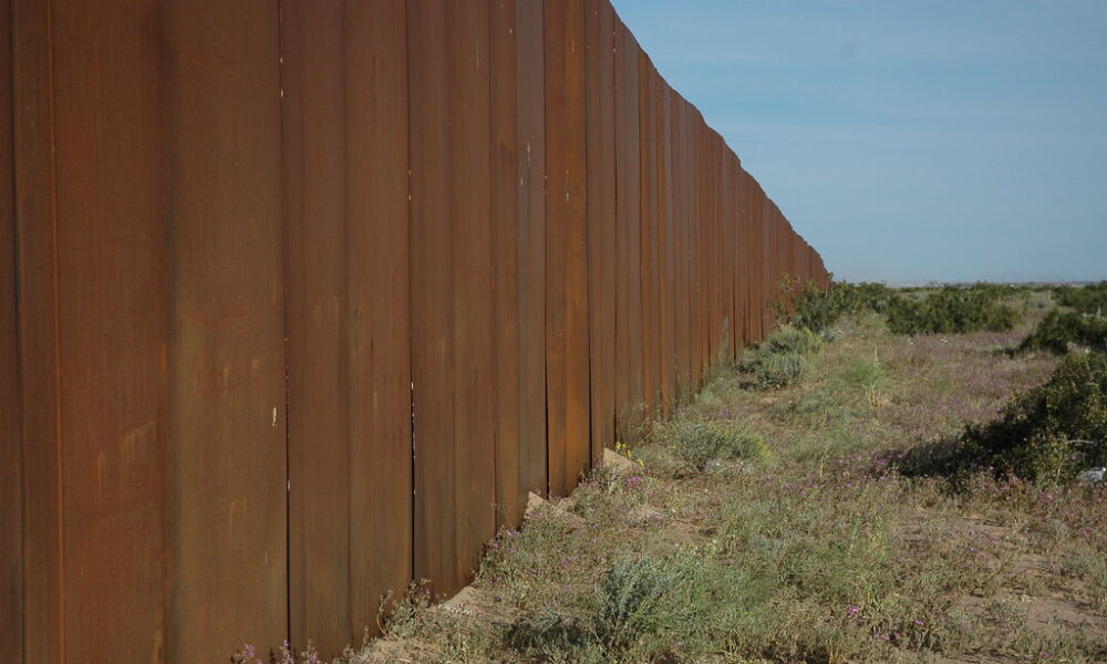I hope someone tears down The Wall, US border, separating Mexico from the US, looking east, along Highway 2, Sonora Desert, Mexican side