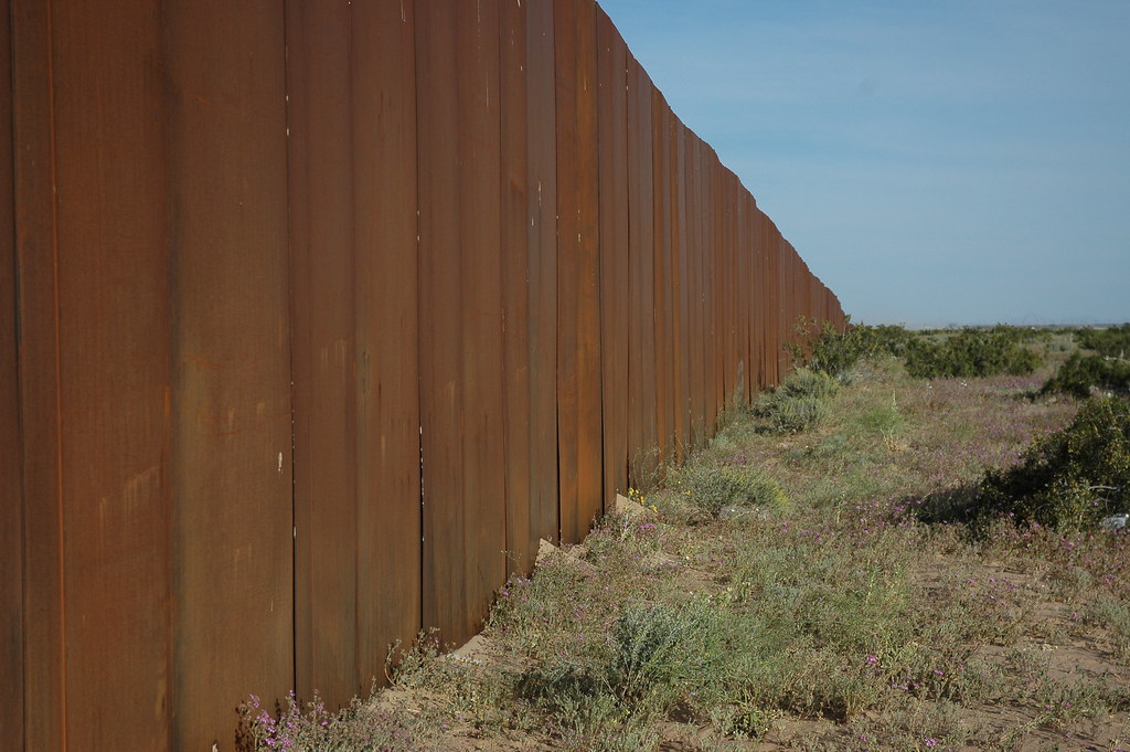 I hope someone tears down The Wall, US border, separating Mexico from the US, looking east, along Highway 2, Sonora Desert, Mexican side